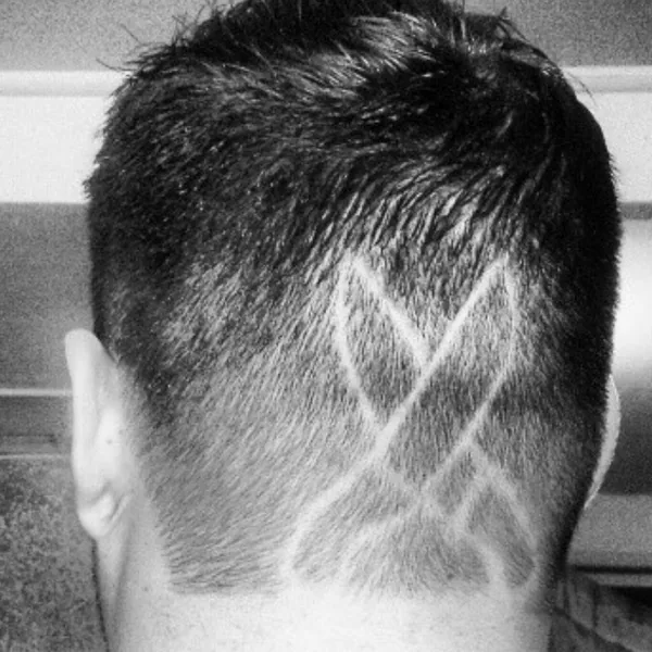 Crossed chef’s knives, razored freehand into his haircut